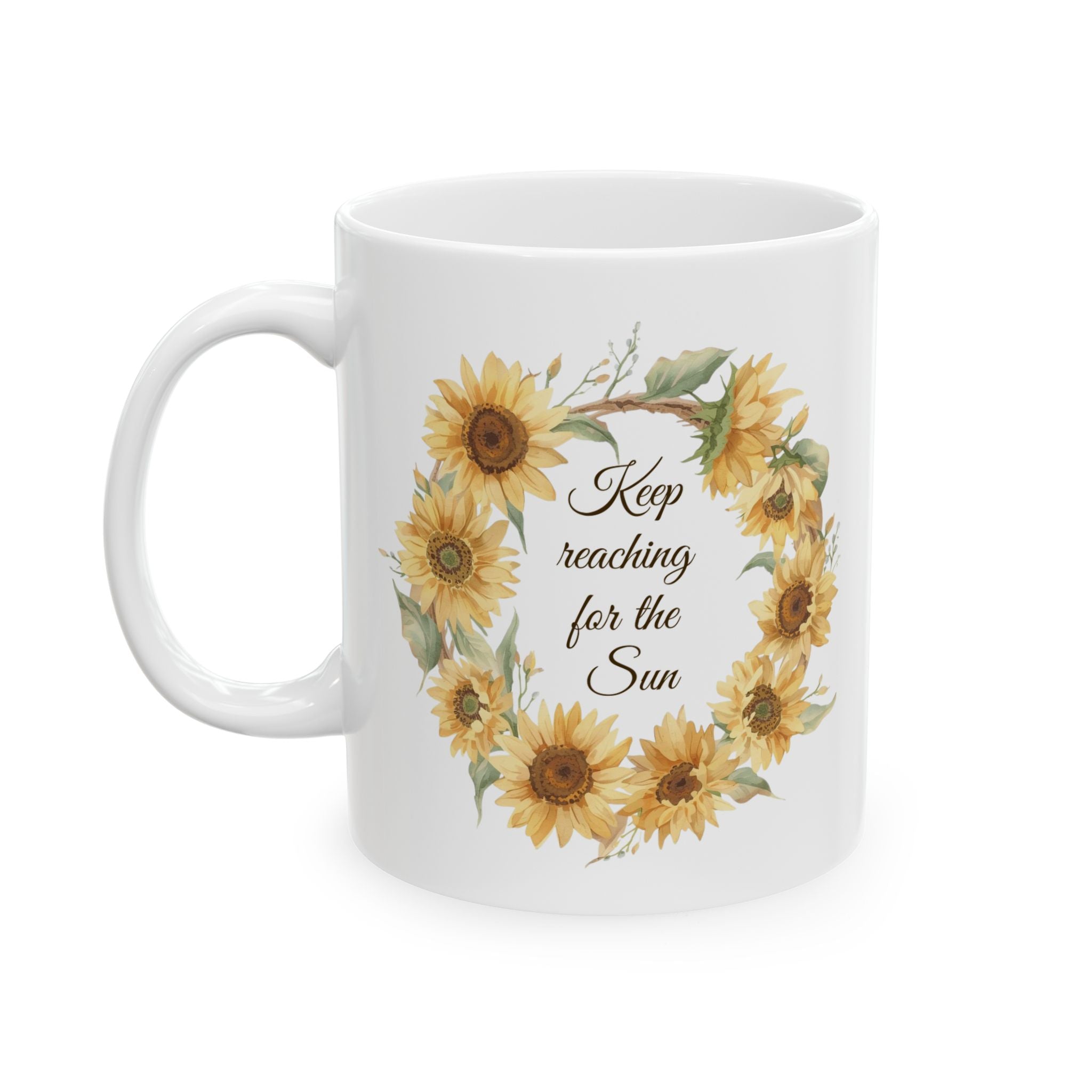 White mug with sunflower design and text 'Keep reaching for the sun' on a white background