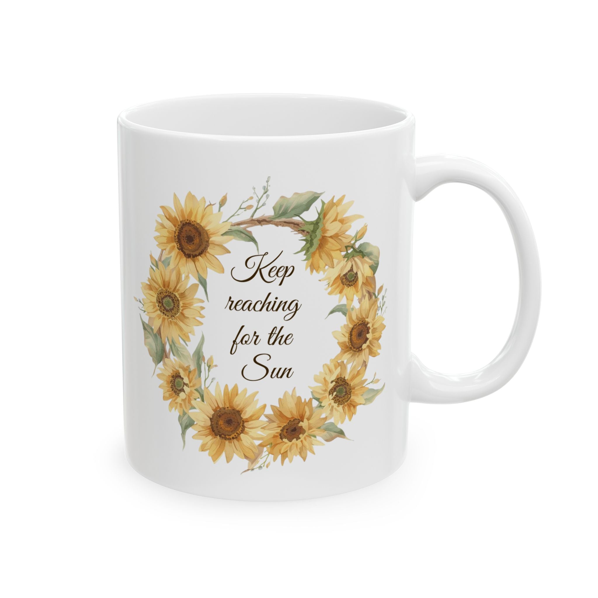 White mug with sunflower design and text 'Keep reaching for the sun' on a white background