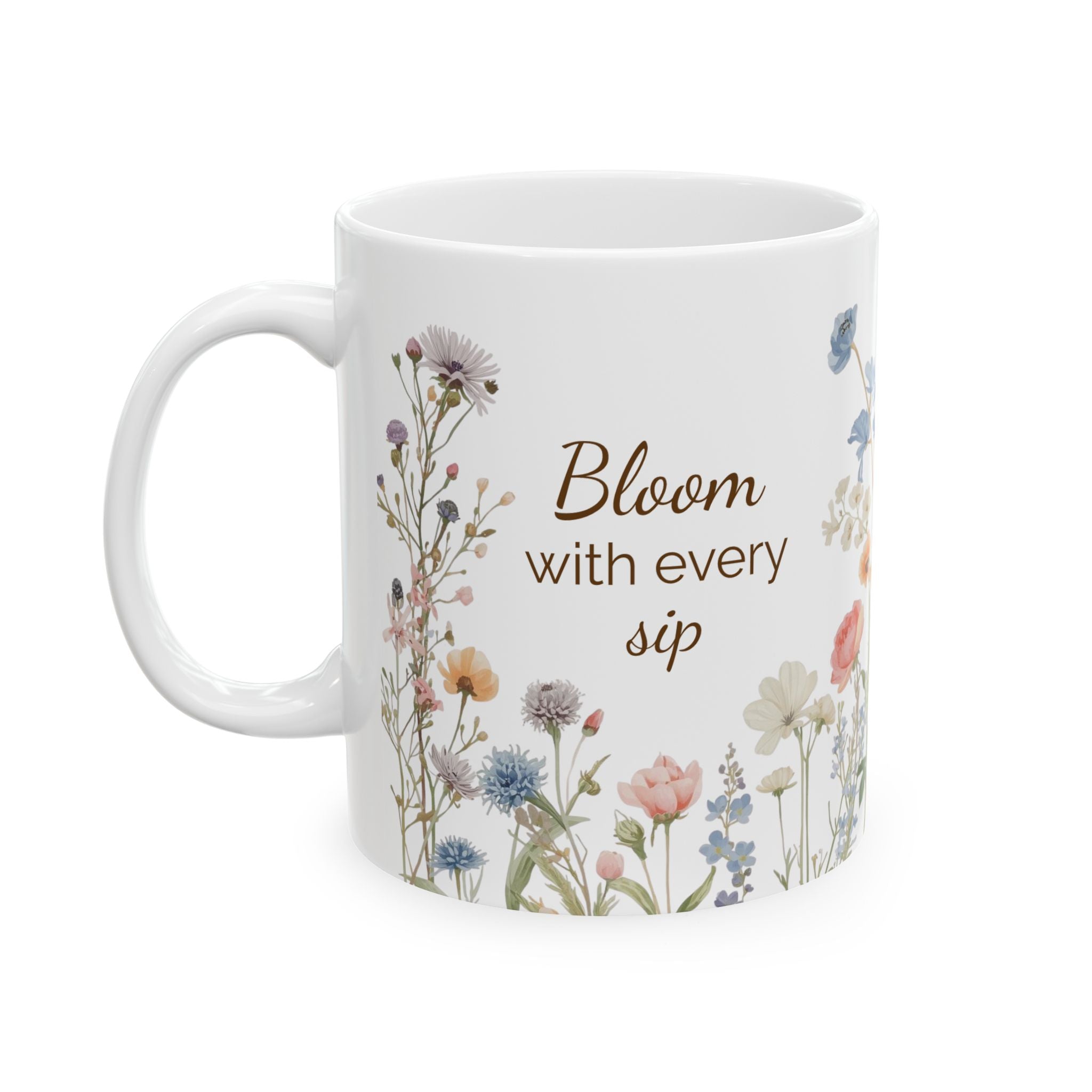 White mug with floral design and text 'Bloom with every sip' on a white background